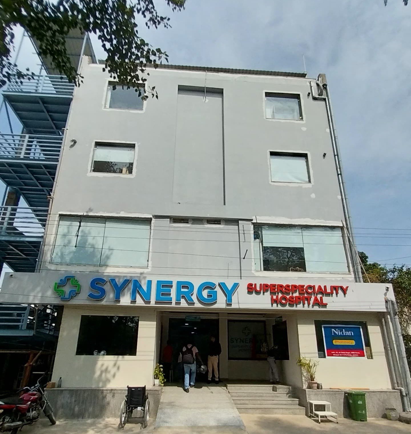 Front view of Synergy Super Speciality Hospital building in Bhopal showcasing the hospital's main entrance and signage.