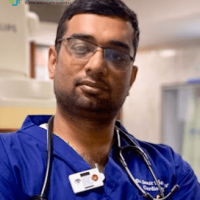 Dedicated Doctor at Synergy Super Speciality Hospital A professional male doctor wearing a stethoscope and blue scrubs at Synergy Super Speciality Hospital in Bhopal.