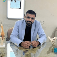 Expert Orthopedic Consultation at Synergy Hospital A healthcare professional seated at a desk with anatomical models, representing orthopedic or specialized medical care at Synergy Hospital in Bhopal.