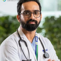 A healthcare professional at Synergy Super Speciality Hospital in Bhopal wearing a white coat and stethoscope.