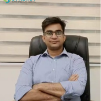 A professional seated in an office chair at Synergy Super Speciality Hospital in Bhopal.